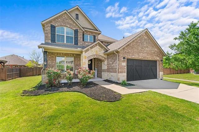 a front view of a house with a yard and porch