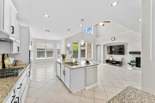 a large white kitchen with a large window