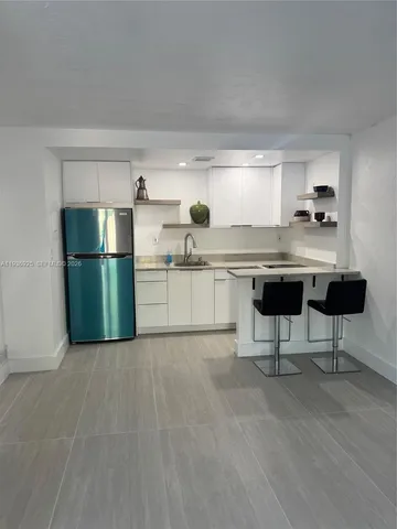a kitchen with a sink cabinets and stainless steel appliances