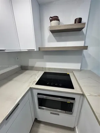 a stove top oven sitting inside of a kitchen