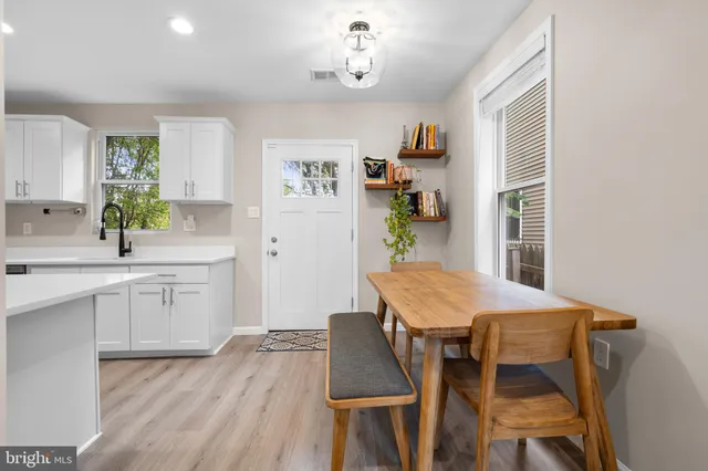 a kitchen with cabinets and wooden floor