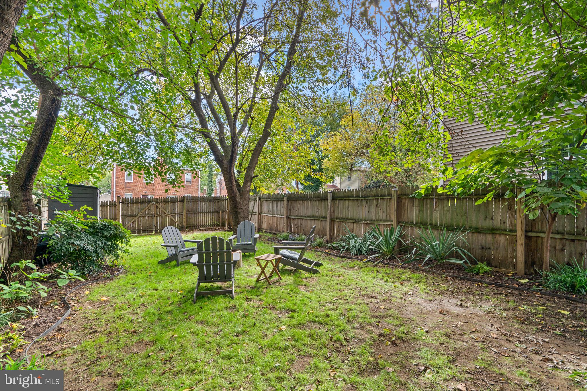 1015 48th Street Northeast Washington, DC 20019 - Photo 17 of 28 a view of backyard with table and chairs and large trees