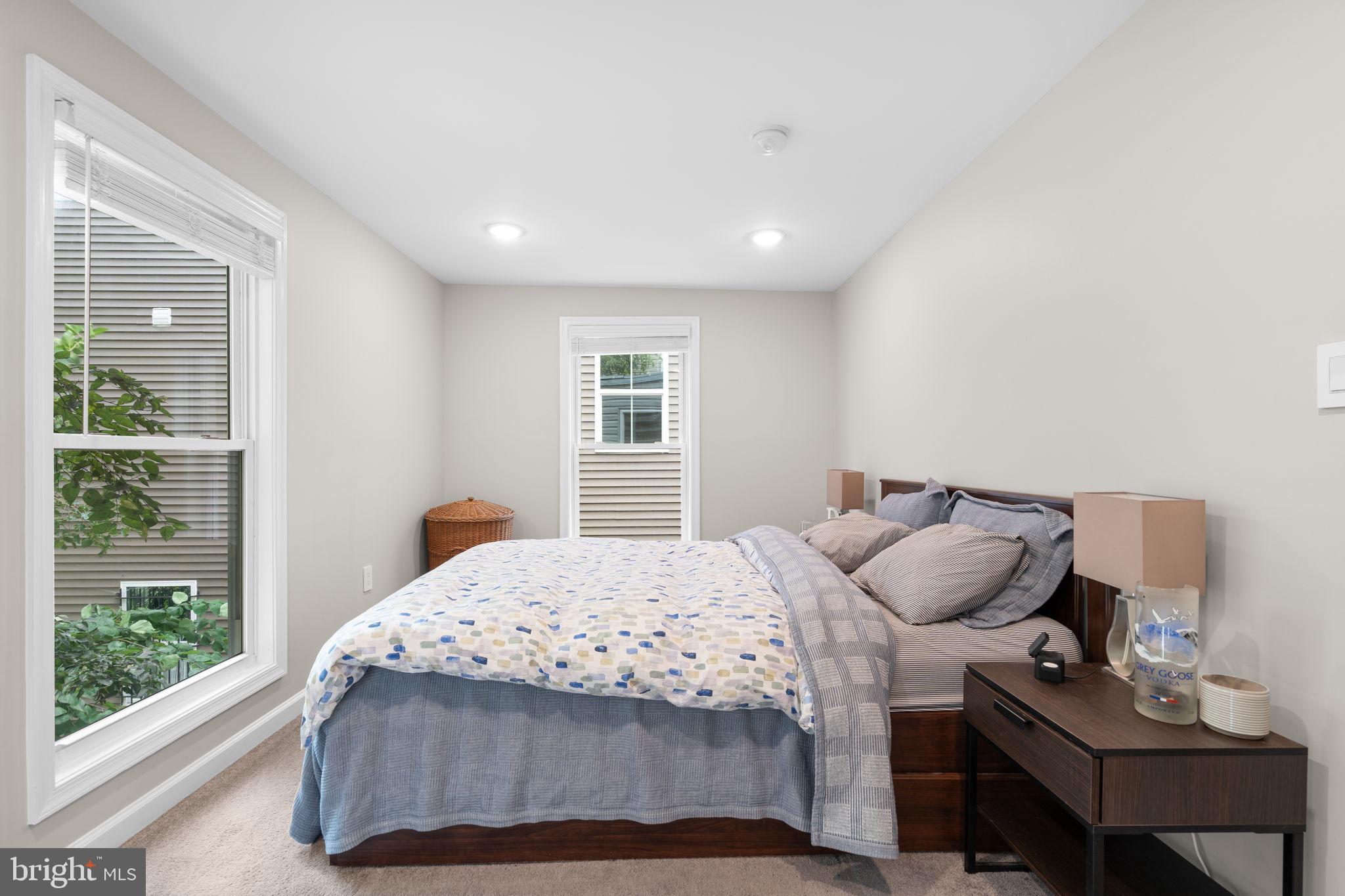 1015 48th Street Northeast Washington, DC 20019 - Photo 19 of 28 a bedroom with a bed a window and a lamp