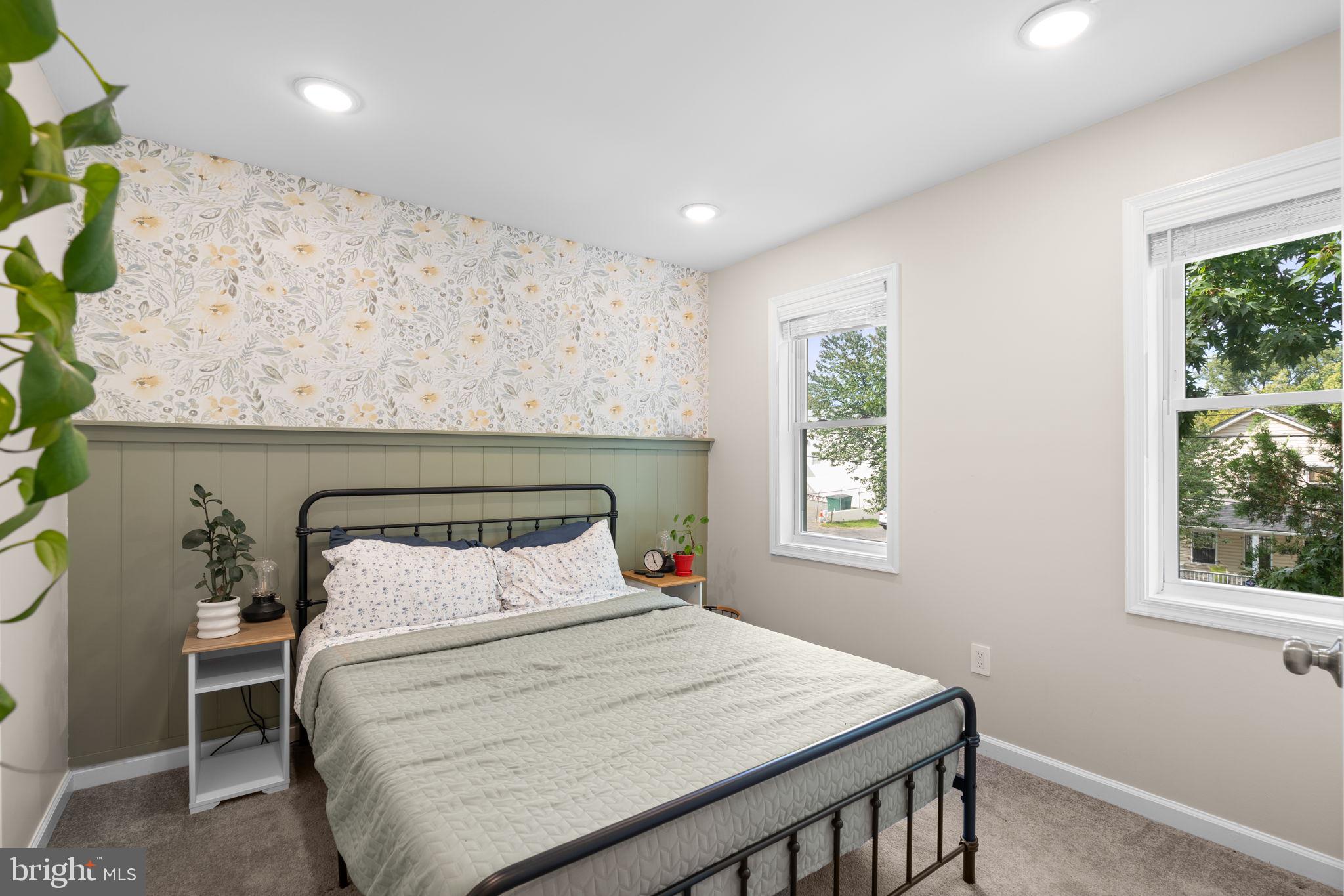 1015 48th Street Northeast Washington, DC 20019 - Photo 21 of 28 a bedroom with a bed a window and potted plant