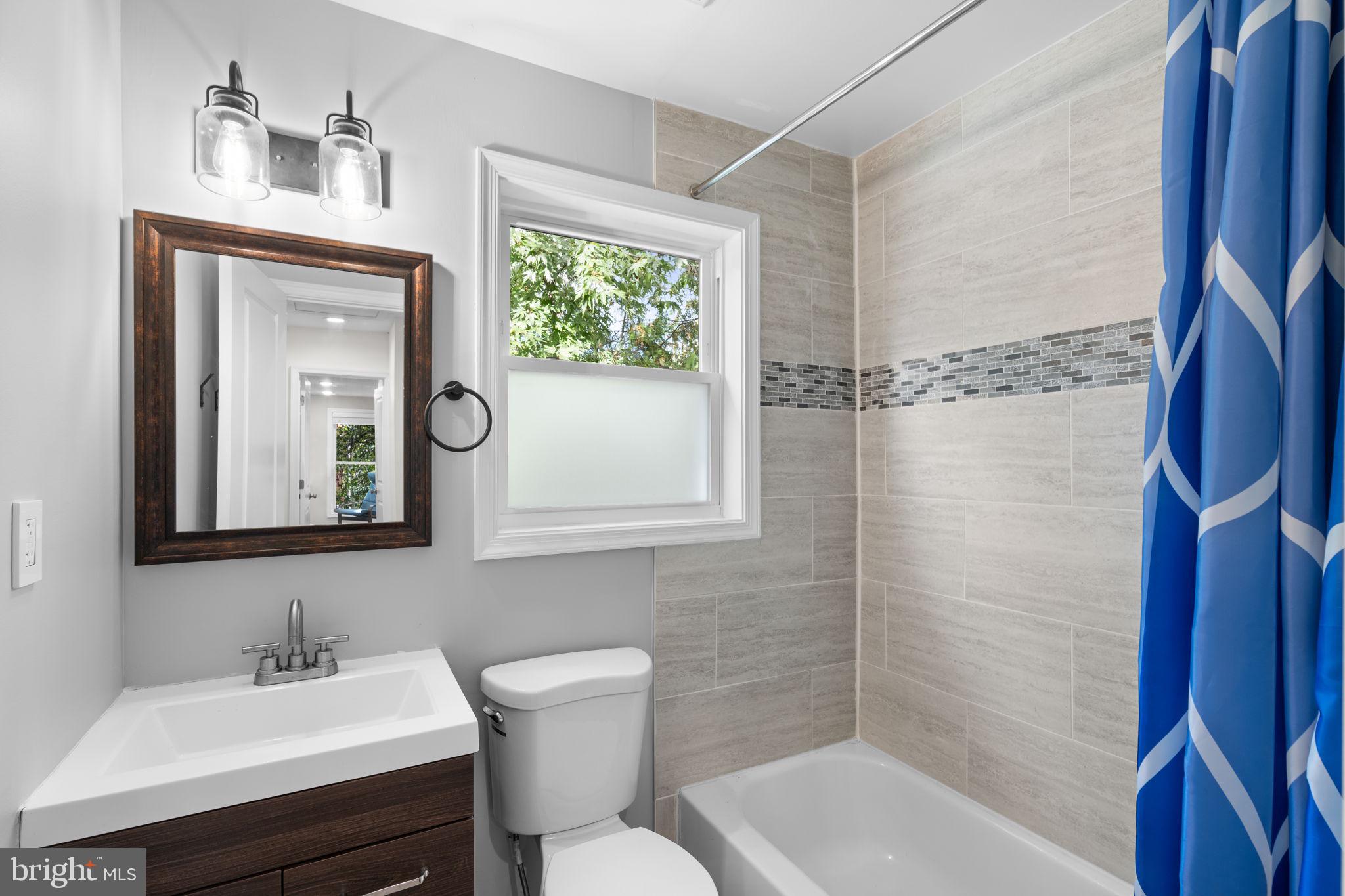 1015 48th Street Northeast Washington, DC 20019 - Photo 23 of 28 a bathroom with a toilet sink and mirror