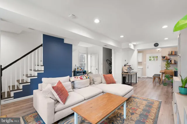 a living room with furniture and wooden floor