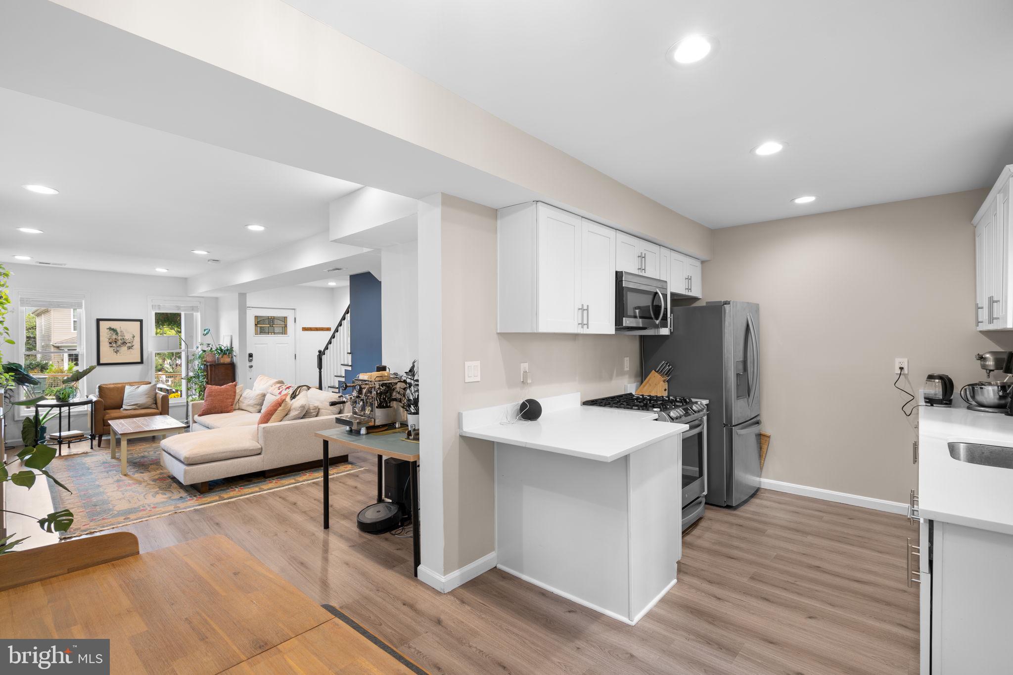 1015 48th Street Northeast Washington, DC 20019 - Photo 8 of 28 a living room with furniture a flat screen tv and a wooden floor