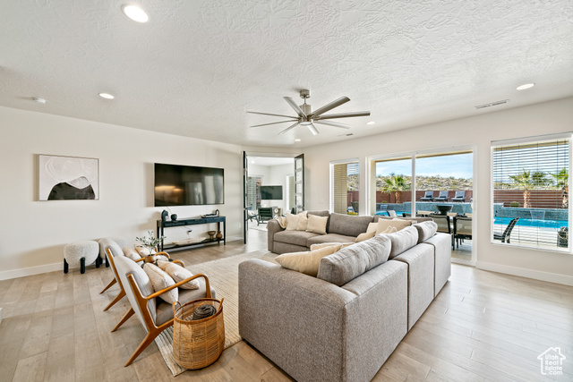 6026 Zen Trail Way St. George, UT 84790 - Photo 19 of 41 Living area with recessed lighting, light wood-style flooring, ceiling fan, and a textured ceiling