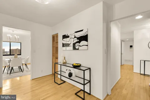 a view of a livingroom with furniture wooden floor and windows