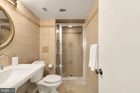 a bathroom with a toilet a sink and shower