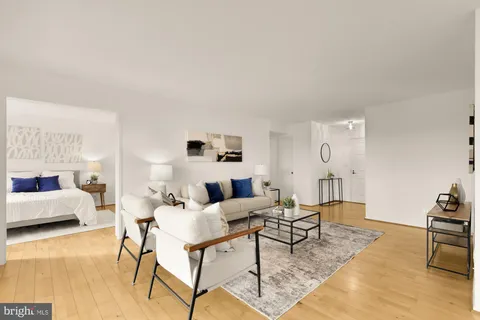 a living room with furniture and wooden floor