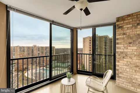 a view of a balcony with furniture and a window