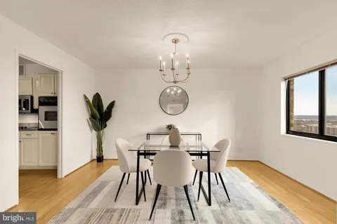a view of a dining room with furniture window and wooden floor
