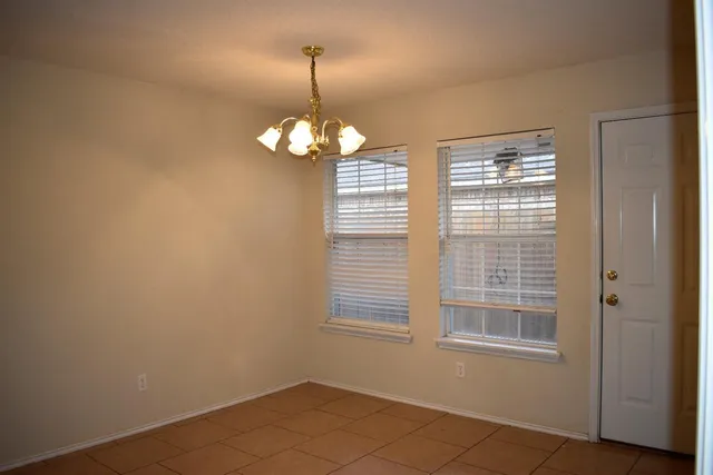 a view of a room with a window and chandelier