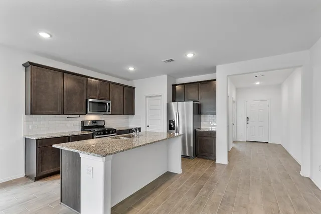 a kitchen with a refrigerator and a sink