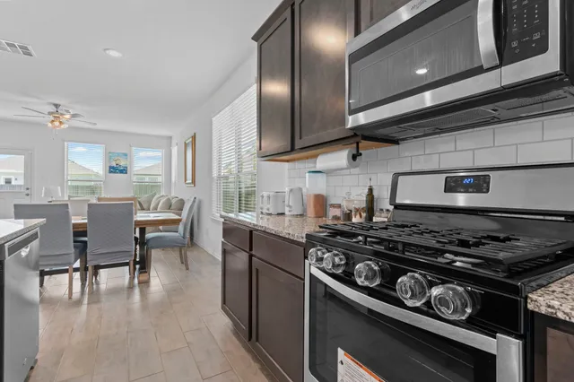 a kitchen with a stove and a wooden floors