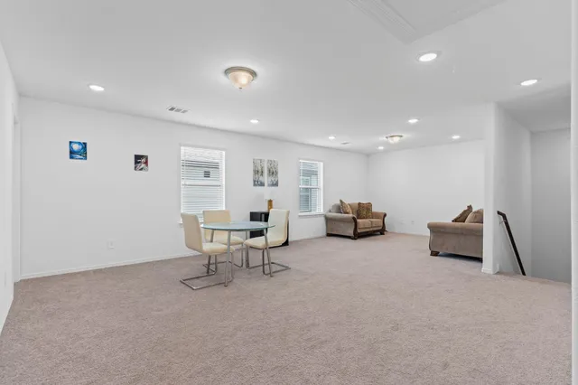 an empty room with a empty space and windows