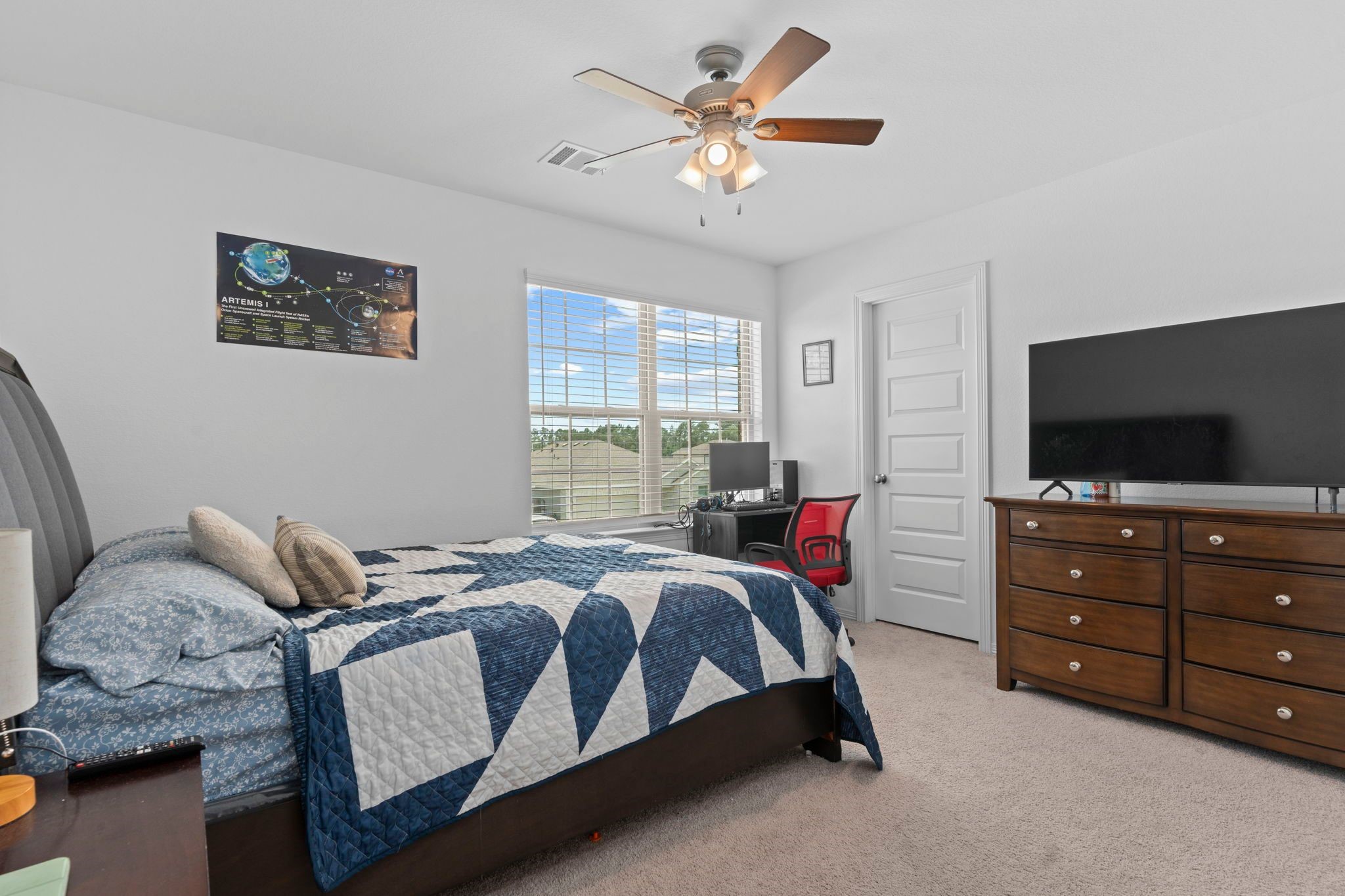 9658 Caney Trails Road Conroe, TX 77303 - Photo 38 of 50 a bedroom with a bed and a flat screen tv