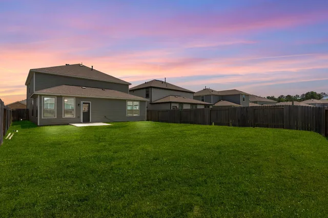 a view of a yard with a house in the background