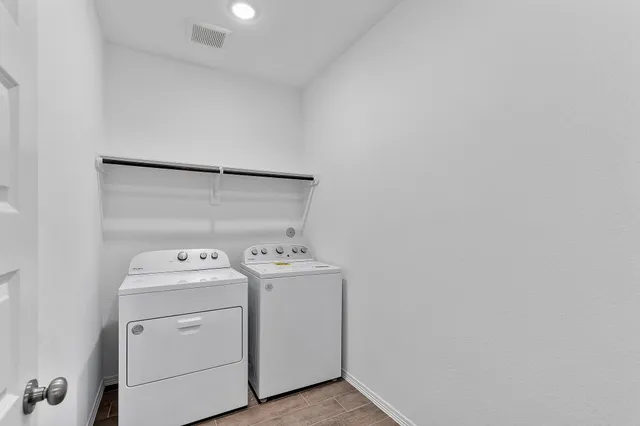 an aerial view of a house with garden space and street view