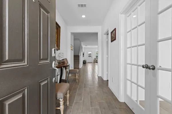 a view of a hallway with wooden floor and staircase