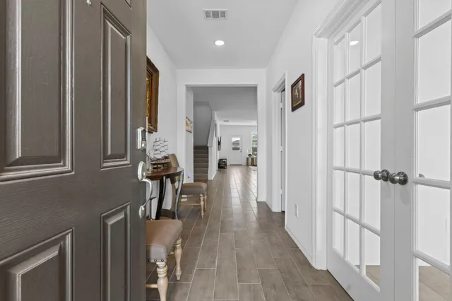 a view of a hallway with wooden floor and staircase