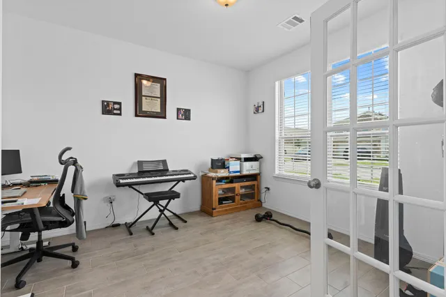 a view of a workspace with furniture and a window