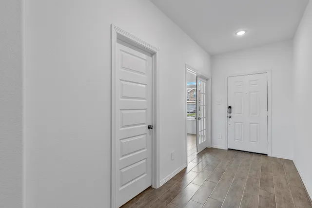 a view of empty room with wooden floor