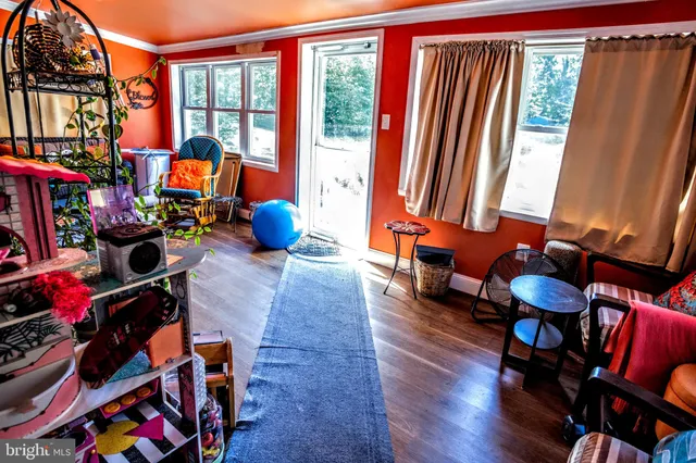 a living room filled with furniture and a window