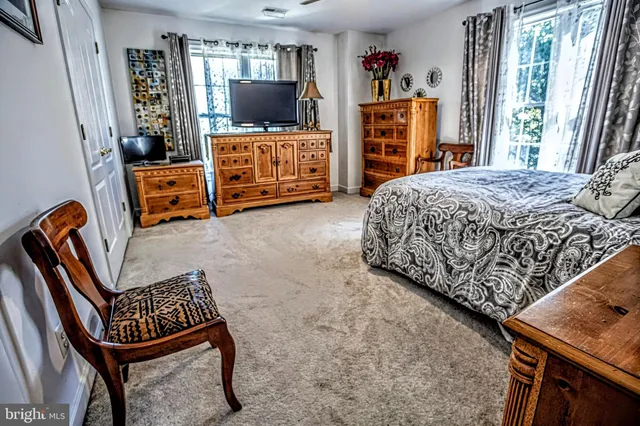 a bedroom with furniture and a flat screen tv