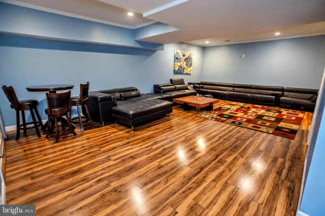 a living room with furniture a rug and a table