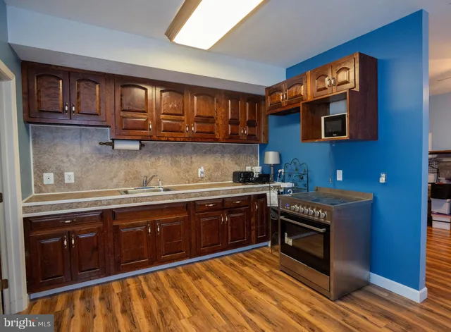 a kitchen with stainless steel appliances granite countertop a stove cabinets and a sink
