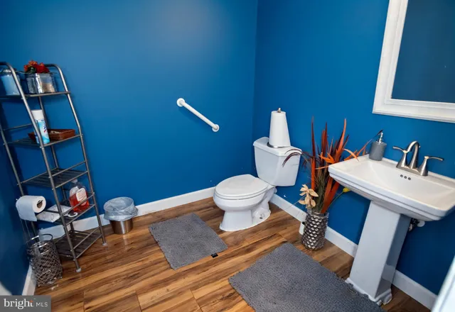 a bathroom with a toilet sink and a mirror