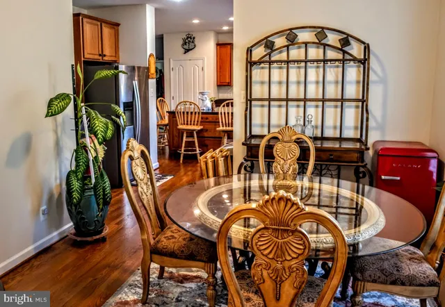 a dining room with furniture potted plants and wooden floor