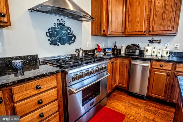 a kitchen with wooden cabinets and a stove top oven