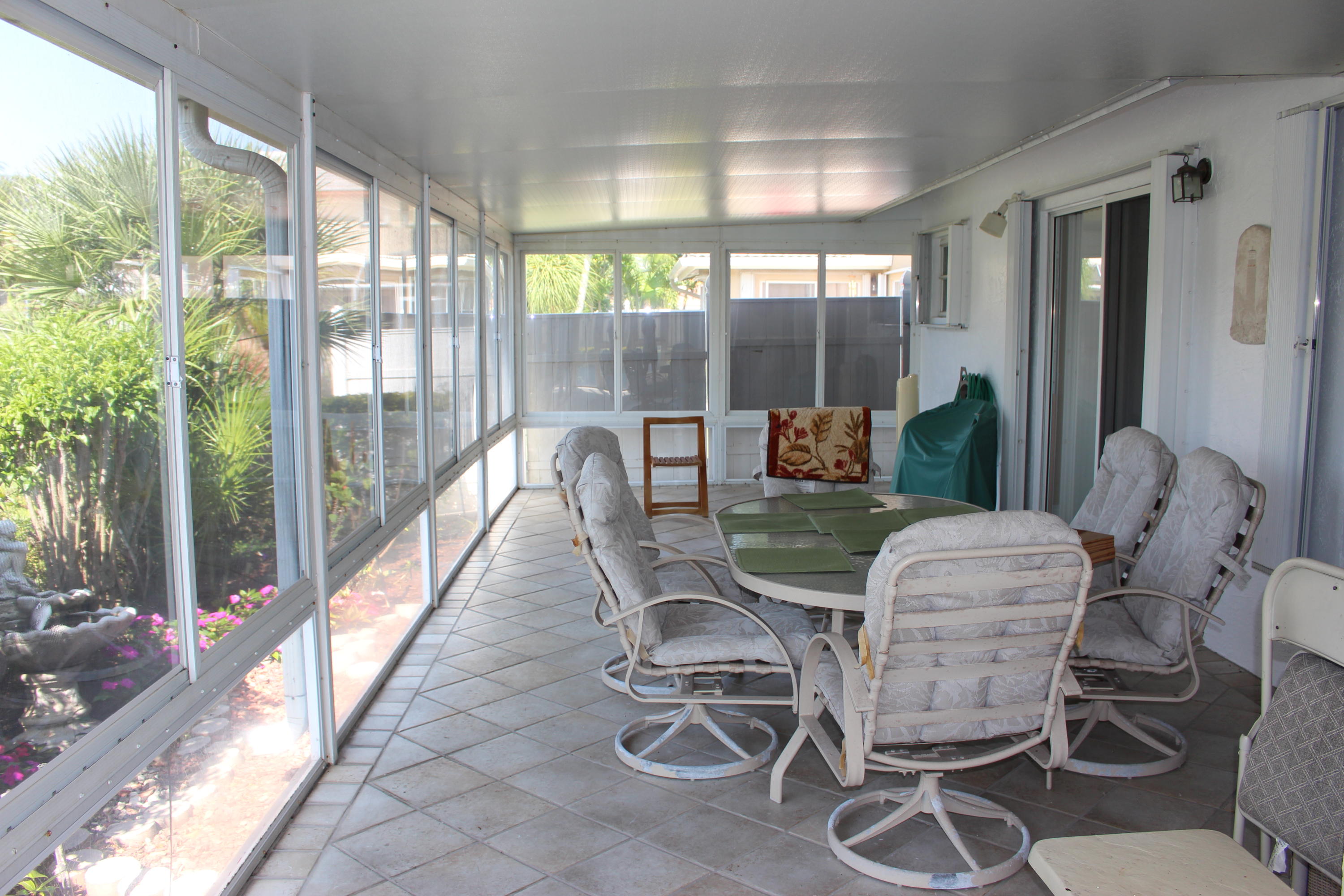 10012 Country Brook Road Boca Raton, FL 33428 - Photo 6 of 25 a view of a dining room with furniture wooden floor and glass windows