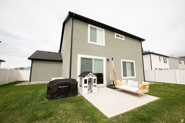 384 Ropelato Drive Nibley, UT 84321 - Photo 18 of 25 Rear view of house featuring a fenced backyard, a patio, and stucco siding