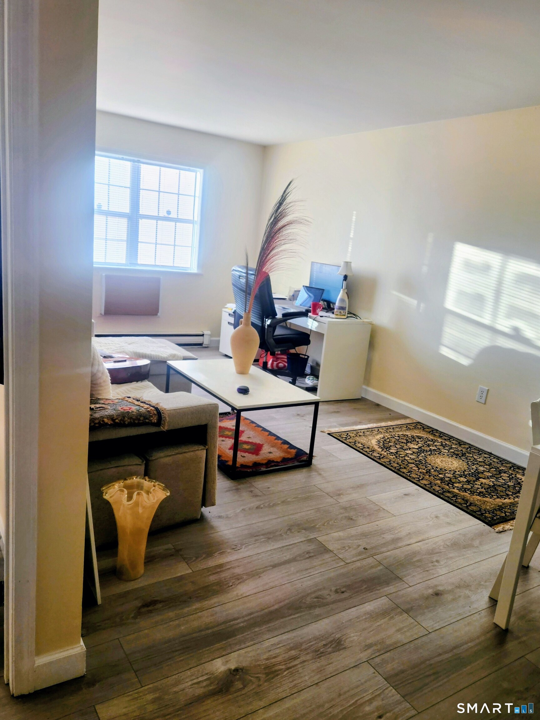 91 4th Street, Unit 7 Ansonia, CT 06401 - Photo 3 of 15 a living room with furniture and a wooden floor