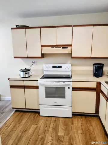 a white kitchen with a sink and a stove