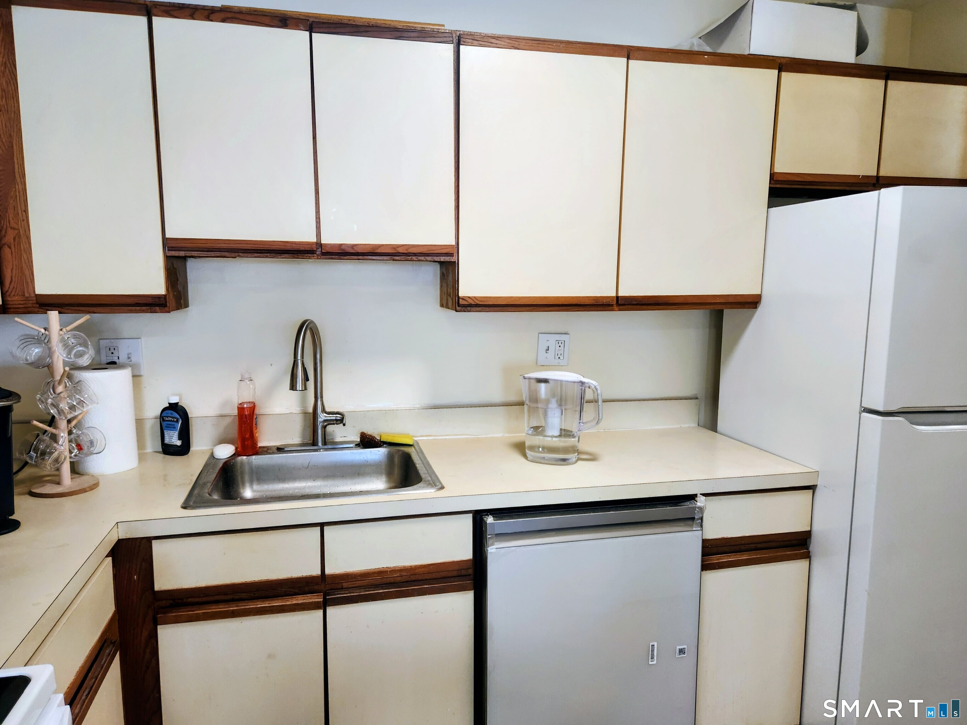 91 4th Street, Unit 7 Ansonia, CT 06401 - Photo 7 of 15 a kitchen with stainless steel appliances a sink a refrigerator and cabinets