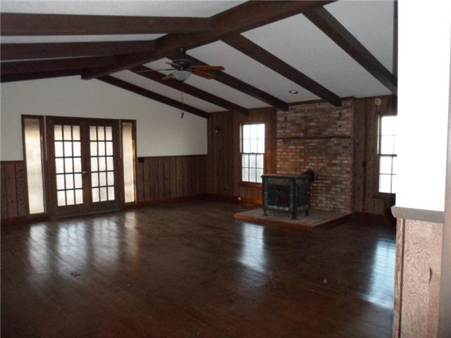 378 Lake Logan Road Ardmore, TN 38449 - Photo 4 of 14 a view of empty room with wooden floor and fireplace