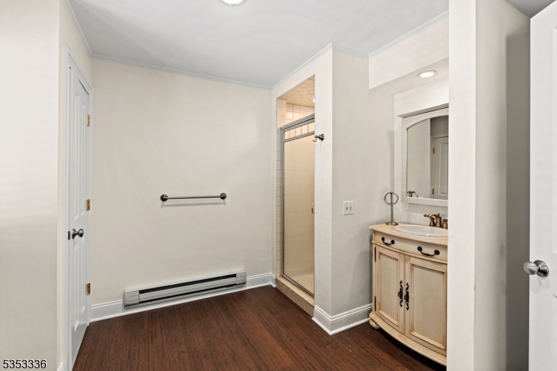 303 Mendham Road Bernardsville, NJ 07924 - Photo 35 of 45 an empty room with wooden floor and mirror