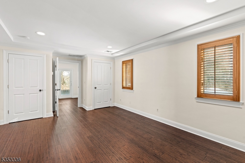 303 Mendham Road Bernardsville, NJ 07924 - Photo 36 of 45 a view of an empty room with wooden floor and windows