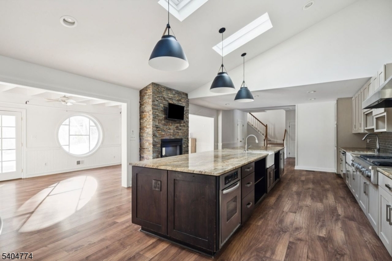 303 Mendham Road Bernardsville, NJ 07924 - Photo 8 of 45 a kitchen with kitchen island granite countertop a stove a sink and a wooden floors