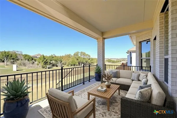a balcony with furniture and a potted plant