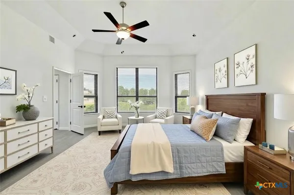 a spacious bedroom with a bed and a couch