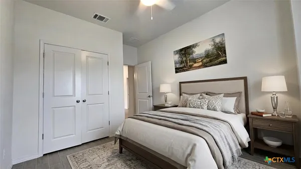 a bedroom with a bed and a chandelier