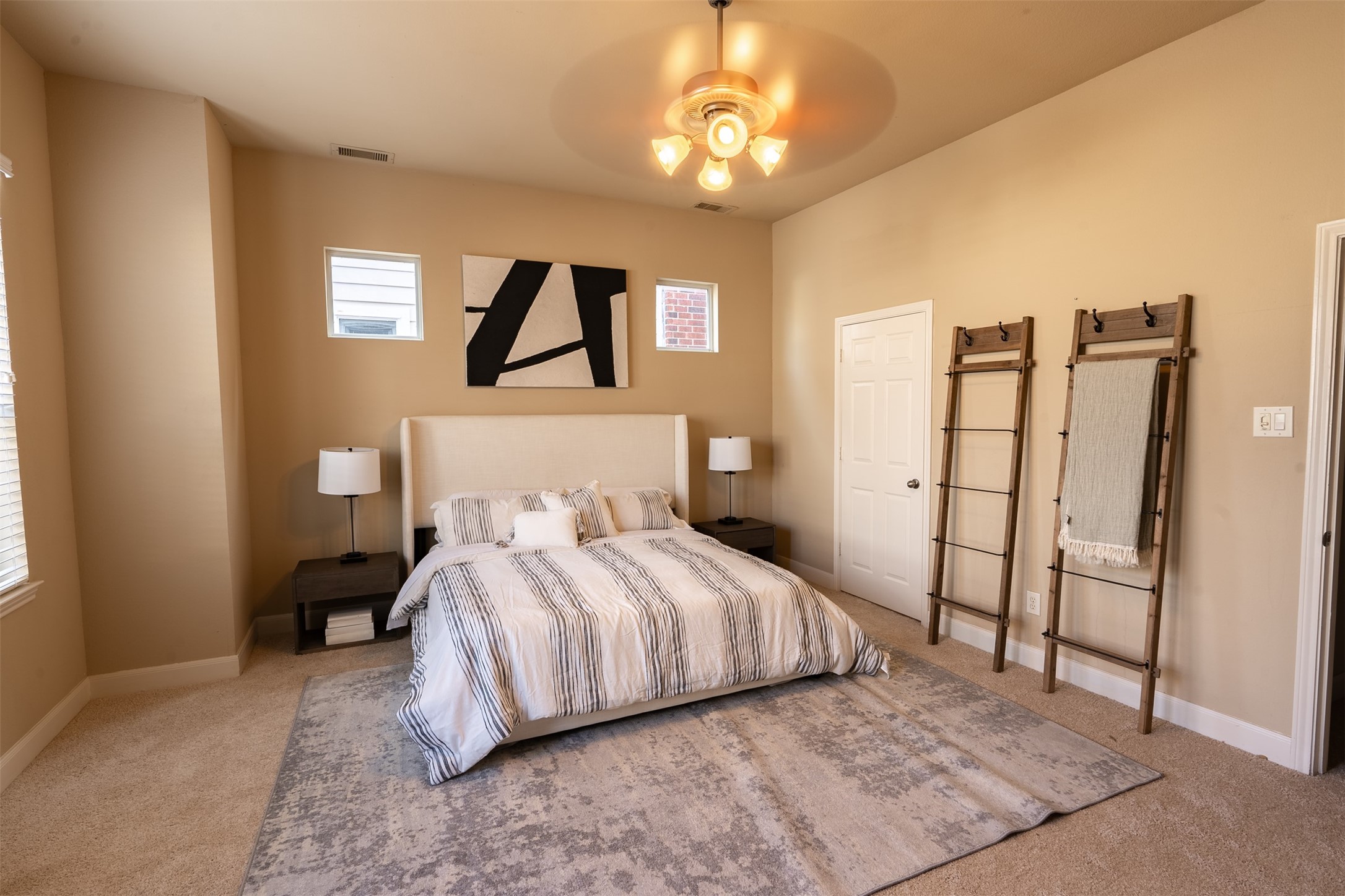 2354 Bastrop Street Houston, TX 77004 - Photo 11 of 21 a bedroom with a large bed and a chandelier