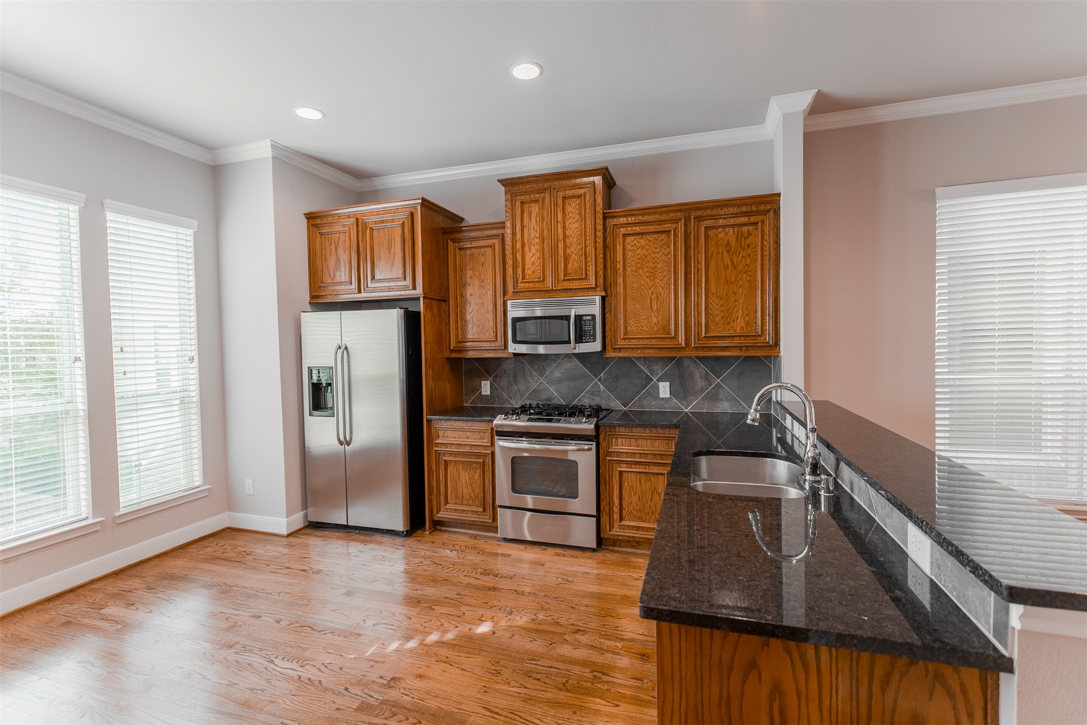 2354 Bastrop Street Houston, TX 77004 - Photo 7 of 21 a kitchen with stainless steel appliances granite countertop a sink stove and refrigerator