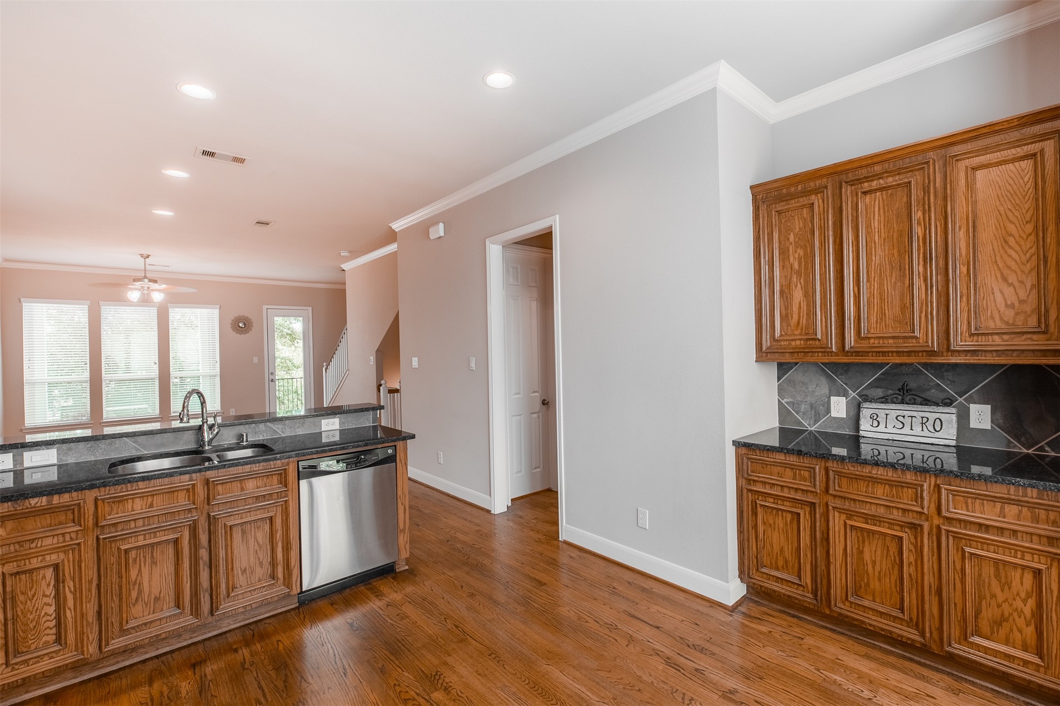 2354 Bastrop Street Houston, TX 77004 - Photo 8 of 21 a kitchen with stainless steel appliances granite countertop a sink and cabinets with wooden floors